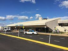 Frontier Airlines aircraft parked at a gate at Trenton-Mercer Airport, highlighting the primary airline operating from TTN.