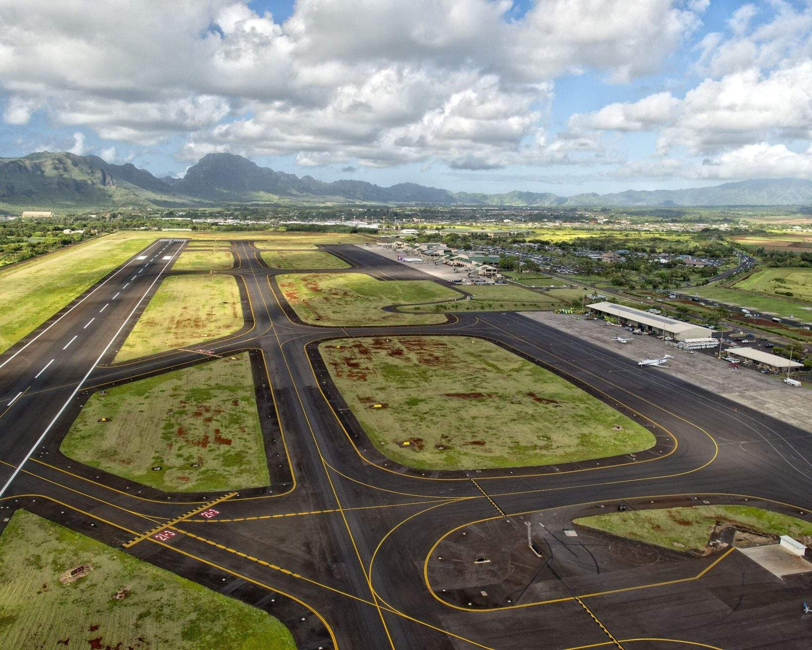 Lihue Airport tarmac with green spaces between runways.