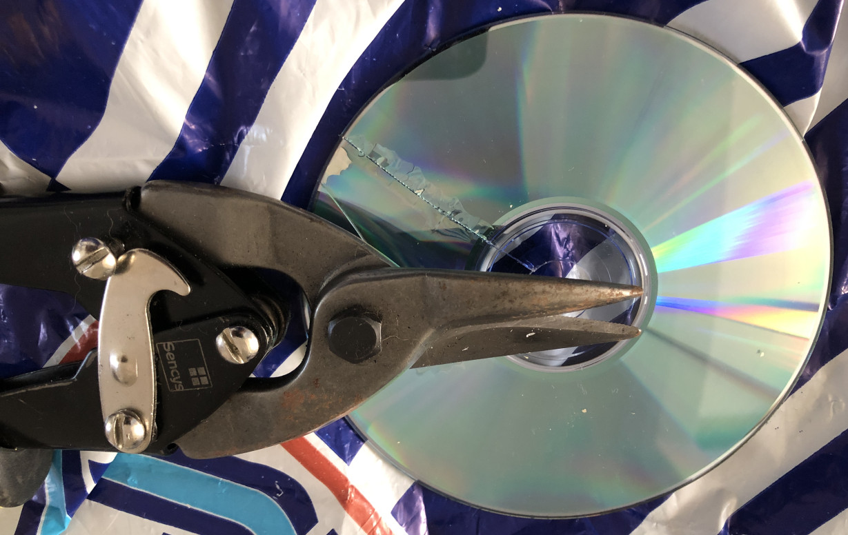 Cut CDs showing damage after using metal shears