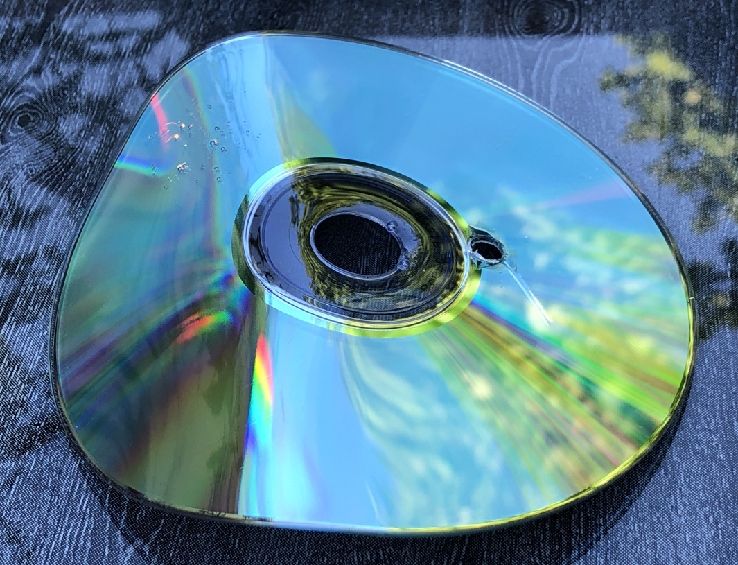 Close-up of heat damaged CD, further illustrating the melting and distortion
