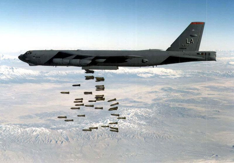 US Air Force B-52 Stratofortress dropping bombs during training, alt text: A U.S. Air Force B-52 Stratofortress releases a series of bombs during a training exercise, demonstrating its payload capacity and bombing accuracy.