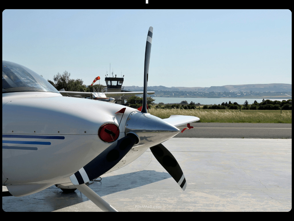 Cessna Propeller with Control Tower in Background