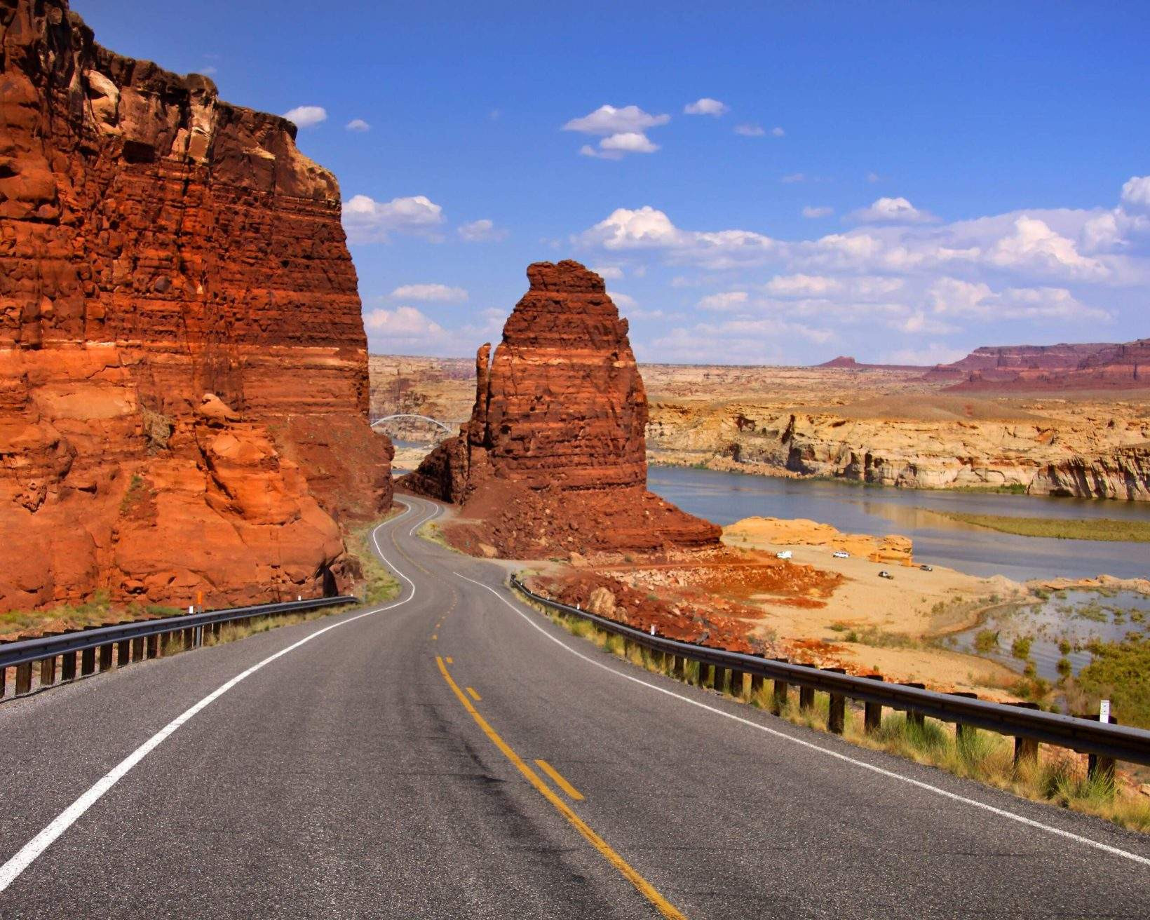 A scenic view of the Grand Canyon with its red and orange sandstone canyons and the Colorado River flowing through it.