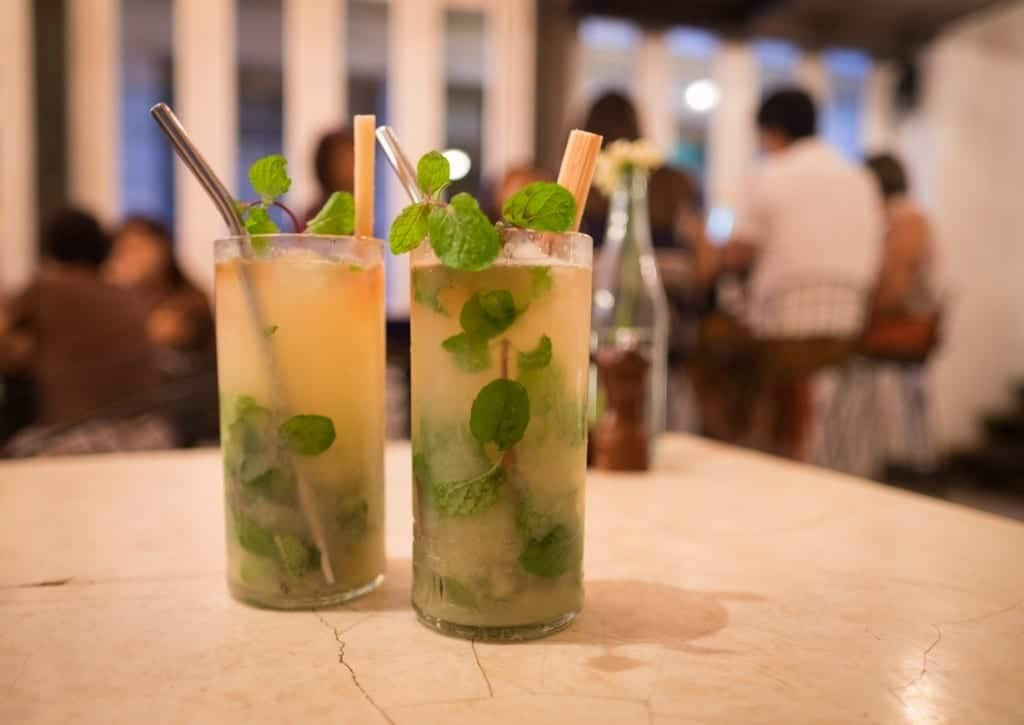 Refreshing Mojitos served in a bar, capturing the vibrant social scene in Cuba.