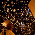 Beautiful sky lanterns illuminating the night sky, created with biodegradable materials, ready to float during a celebration.