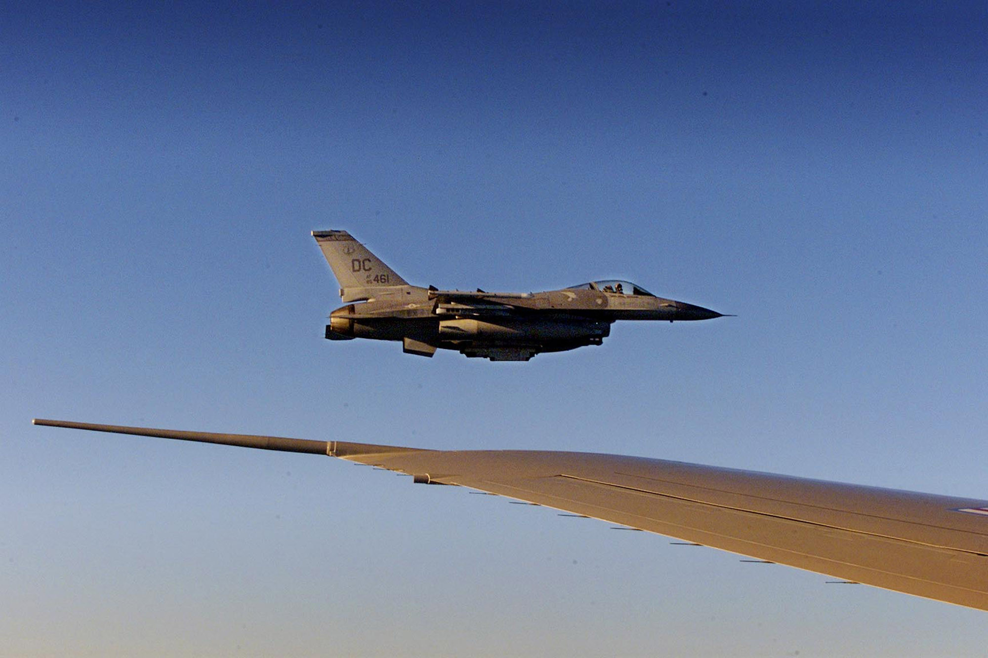 An F-16 fighter flies just off the wing of Air Force One on a flight back to Washington, Sept. 11, 2001.
