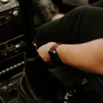 Pilots in a helicopter cockpit, representing the technology and expertise required for helicopter operation and long-distance flights