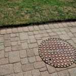 A sturdy concrete manhole cover, similar to the type used in the Pascal-B nuclear test, highlighting the object that was launched at incredible speed.