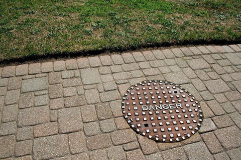 A sturdy concrete manhole cover, similar to the type used in the Pascal-B nuclear test, highlighting the object that was launched at incredible speed.