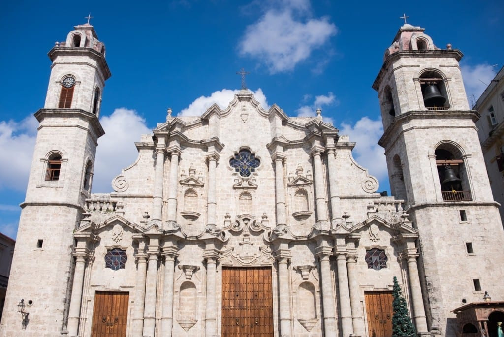A charming church in Old Havana, bathed in sunlight against a clear blue sky, representing the historical architecture of the city.