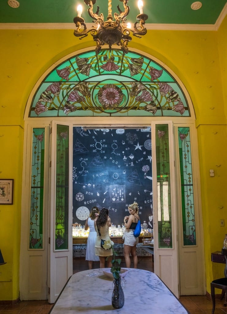 Intricate green and purple stained glass windows in the Museum of Perfume, Havana, adding an artistic touch to the city's cultural scene.