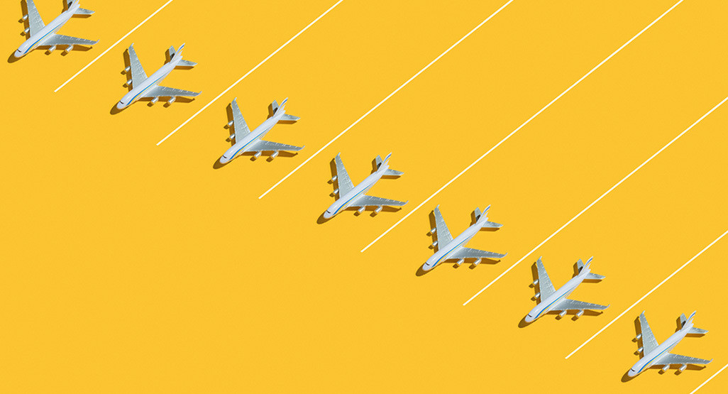 toy airplanes lined up diagonally on a bright yellow background