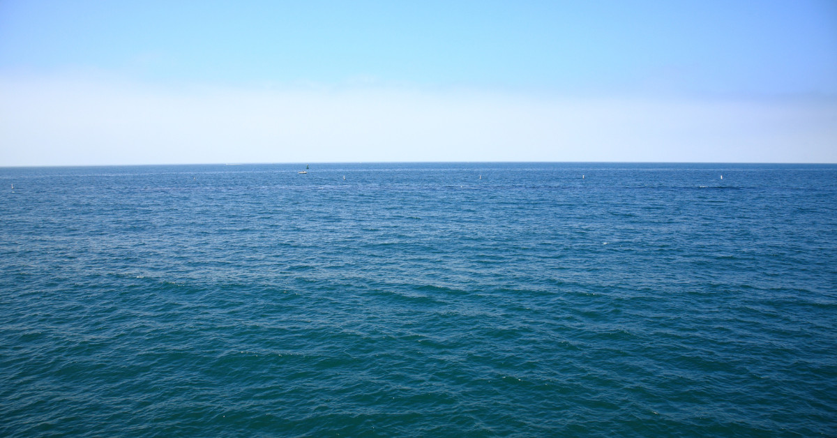 A serene ocean vista under a clear blue sky.