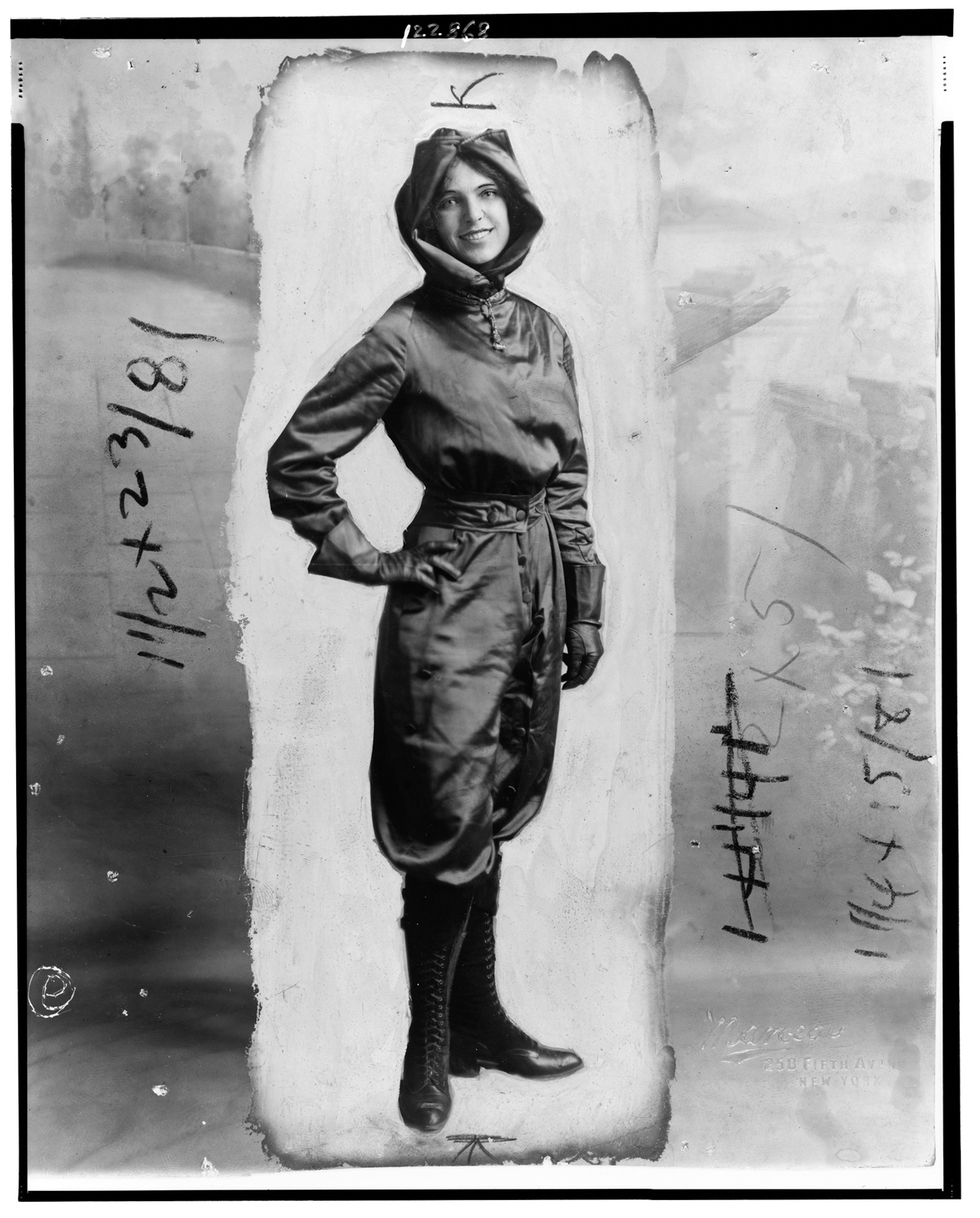 Woman stands for portrait with pilots gear on.