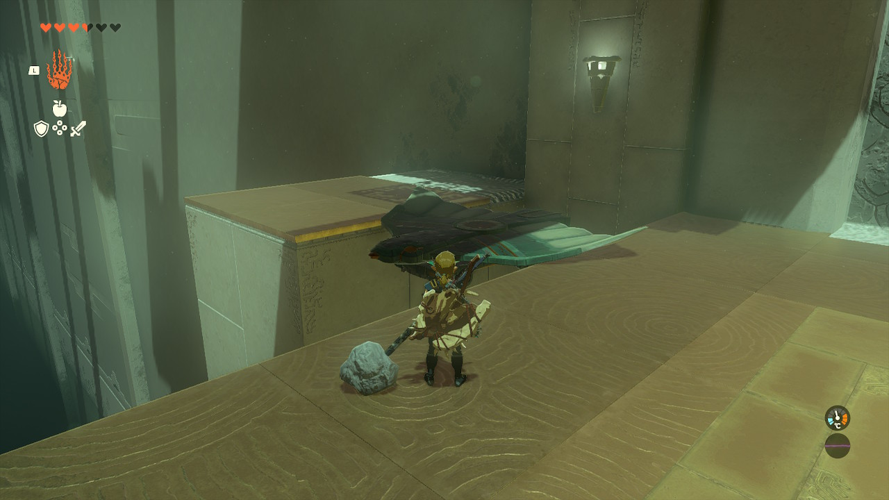 Link carefully placing a wing to form a bridge between ledges in the Jirutagumac Shrine, solving a puzzle with a makeshift flying device component in Zelda Tears of the Kingdom.