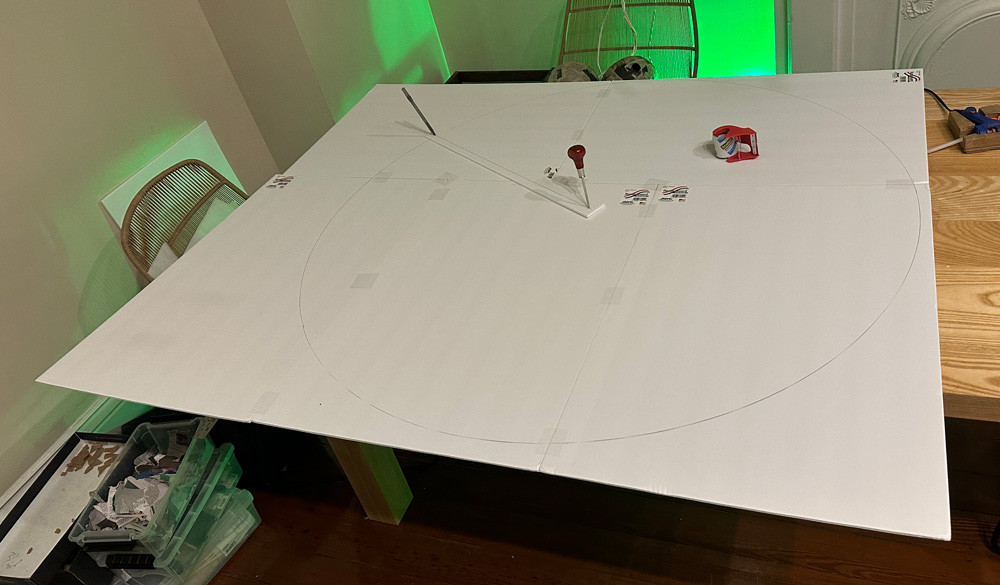Cutting a big circle on foam board, the first step in crafting the base disks of the flying saucer.