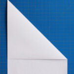 Step 1: Folding the top right corner diagonally to create a sharp crease for the initial wing guideline