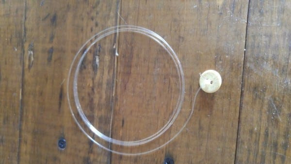 Tying fishing line to a button