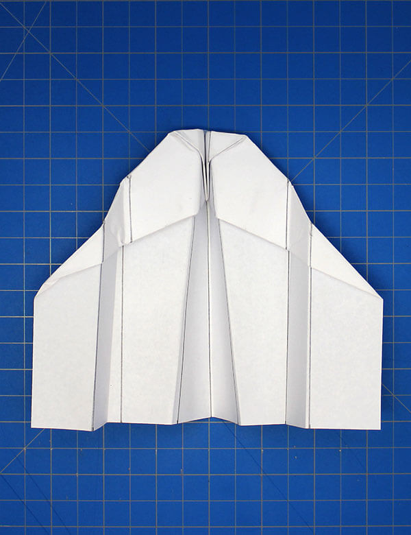 Step 14: Taping the nose of the paper plane to maintain its aerodynamic shape during flight