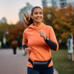 Woman holding a semaglutide pen with airplane in background, representing travel preparedness