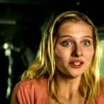 Jane Widdop as Laura Lee inside the crashed Cessna plane in Yellowjackets, looking determined