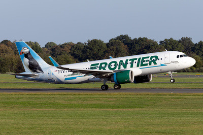 Frontier Airlines Airbus A320 landing at an airport, showcasing the airline's branding with an animal on the tail fin.