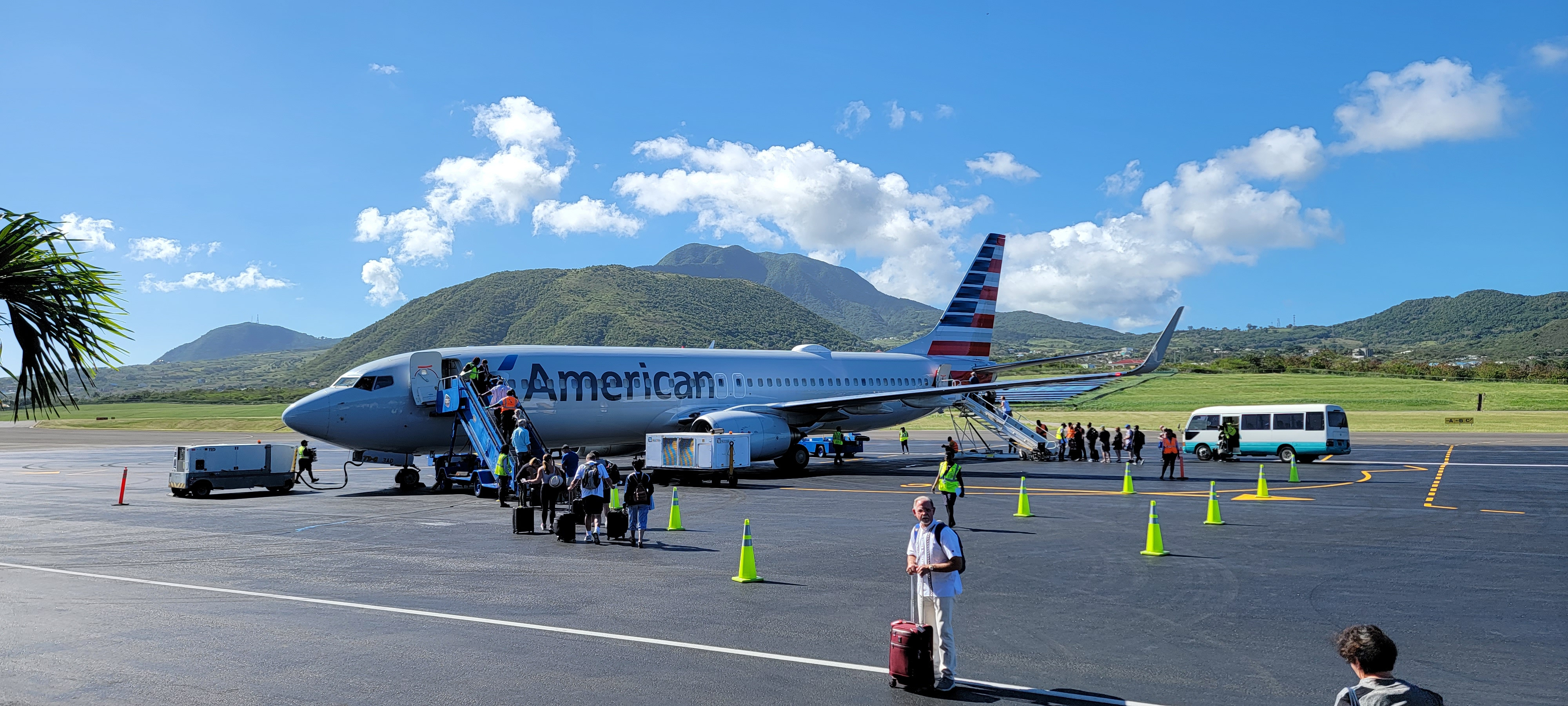 Passengers waiting at airport gate, alt text: Passengers await standby confirmation at the airport gate for an American Airlines flight