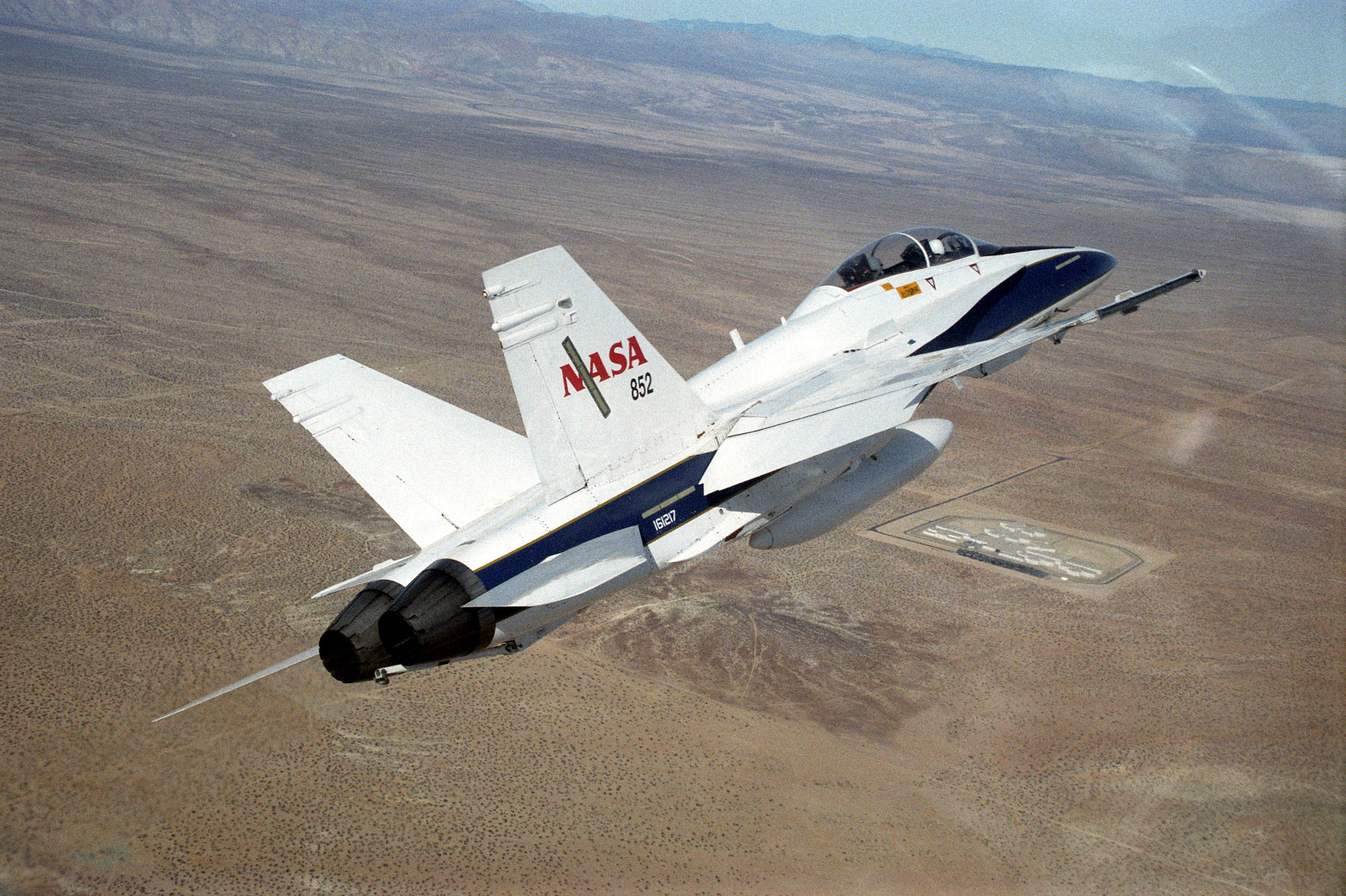 An F/A-18-A flies over California’s Mojave Desert, showcasing its impressive speed and maneuverability.