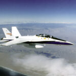 An F-18 is in flight over the California desert showcasing its impressive speed.