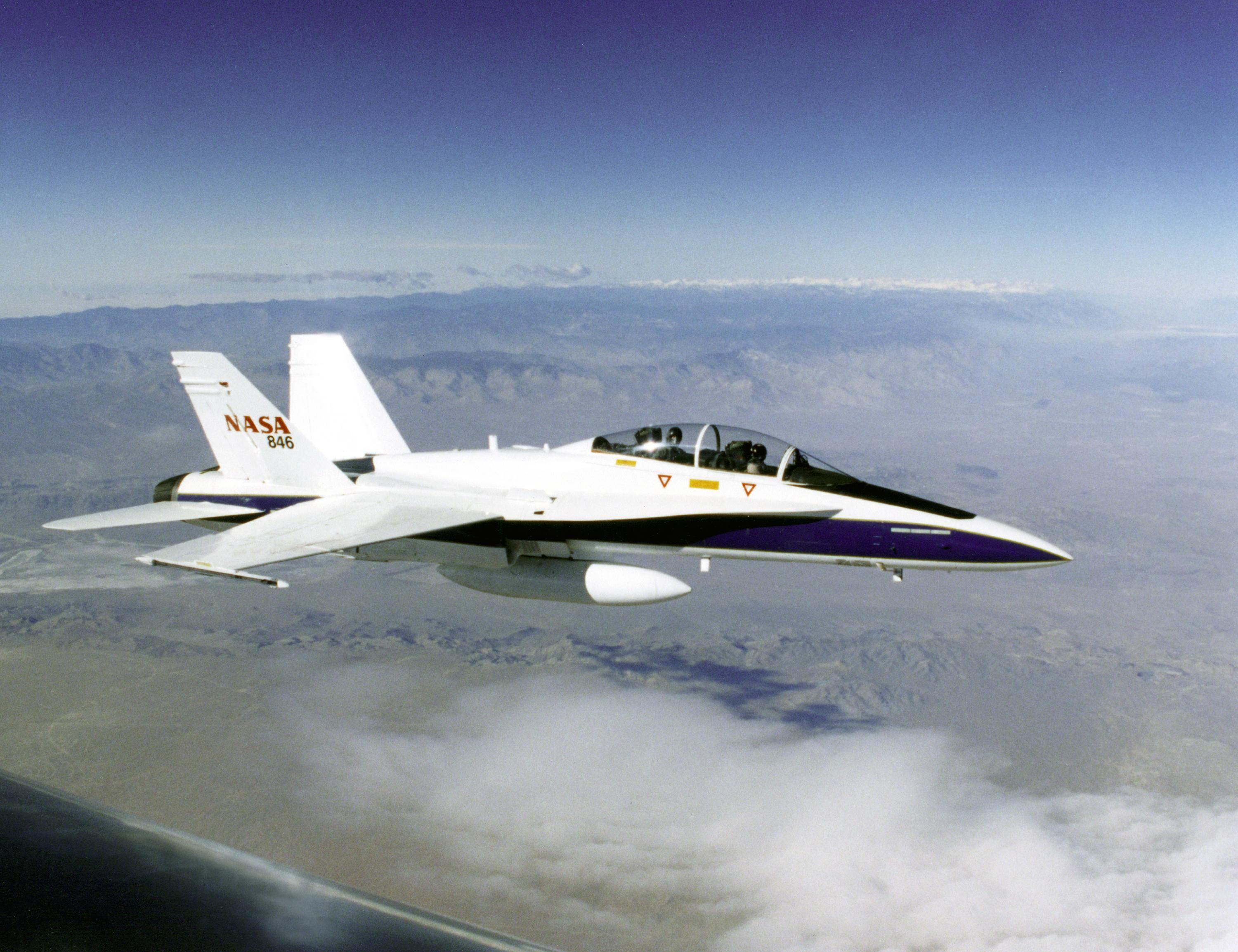 An F-18 is in flight over the California desert showcasing its impressive speed.