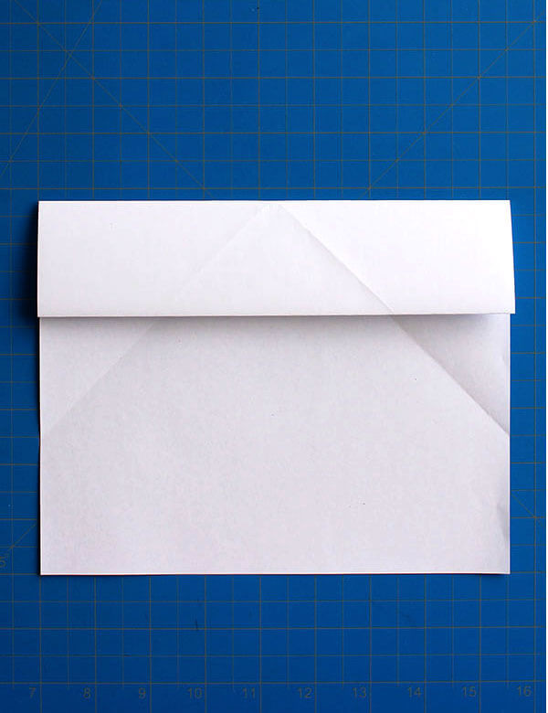 Step 6: Folding the top section down again along the horizontal crease to define the wing edge