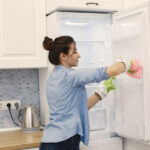 Fruit flies swarming around overripe fruit, attracting pests