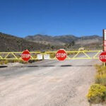 Warning signs posted at the entrance to Area 51, clearly stating the prohibition of photography and unauthorized entry