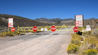 Warning signs posted at the entrance to Area 51, clearly stating the prohibition of photography and unauthorized entry