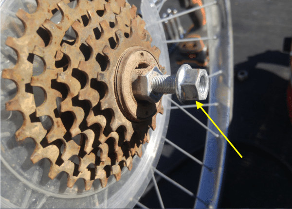 Unscrewing the wing nut from the bike wheel axle