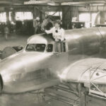 Amelia Earhart stands in the cockpit of her unfinished Lockheed Electra 10E Special, serial number 1055, at the Lockheed Aircraft Company factory, Burbank, California, 1936. (Purdue University Libraries, Archives and Special Collections)