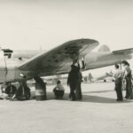 Lockheed technicians checking the Electra with the airplane in a normal flight attitude
