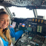 Angelie Nieves Jiménez in the cockpit of a plane with lots of instruments.