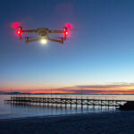 Drone flying at night with anti-collision lights, showcasing safety equipment