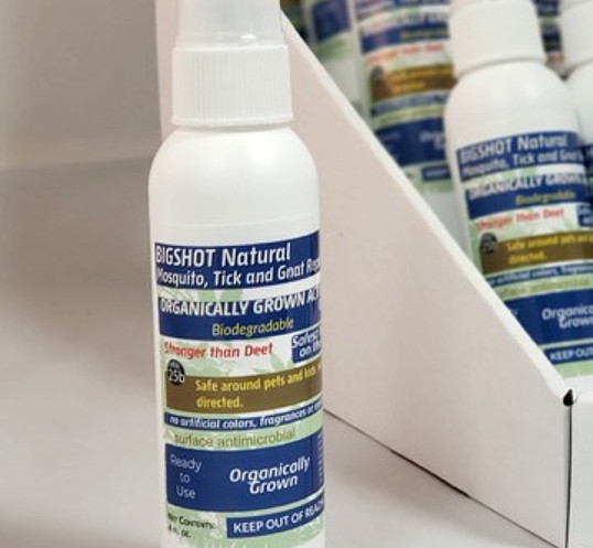 A person applying insect repellent