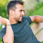 Black fly bites on a person's neck causing inflammation and irritation