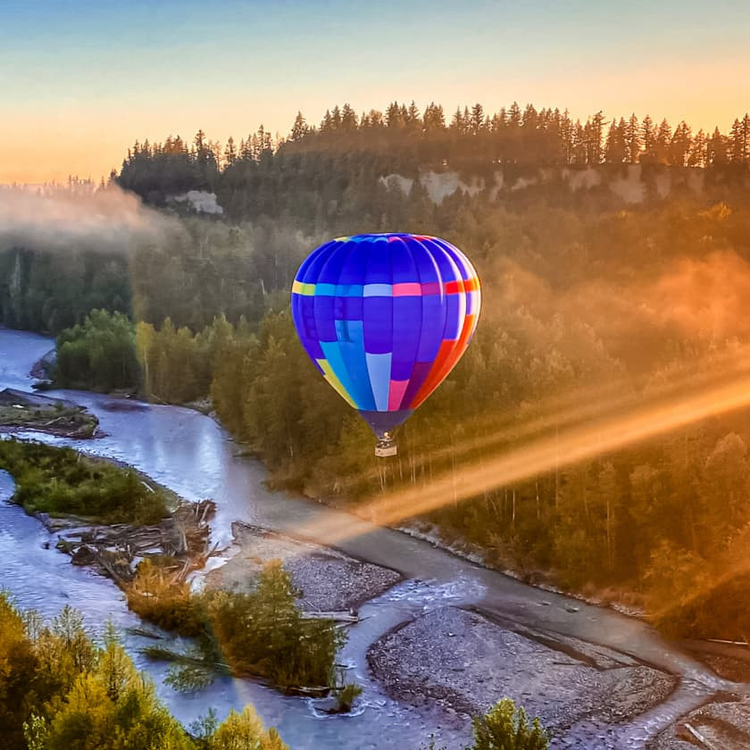 Hot air balloon taking off at sunrise