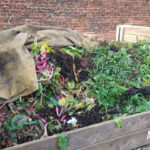 compost bin with cloth tarp folded out of the way