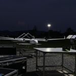 Drone pilot reviewing pre-flight checklist at night