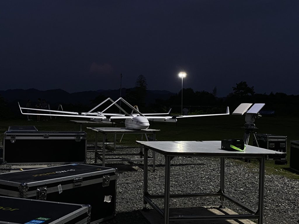 Drone pilot reviewing pre-flight checklist at night