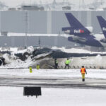 Wreckage of the Delta Airlines plane that crashed upon landing at Toronto Pearson Airport is seen on a tarmac as the investigation continues two days after the incident on February 19, 2025.