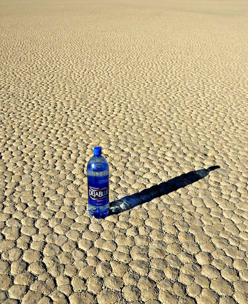 Desert with a bottle of water illustrating dehydration