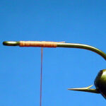 Thread base on the hook shank