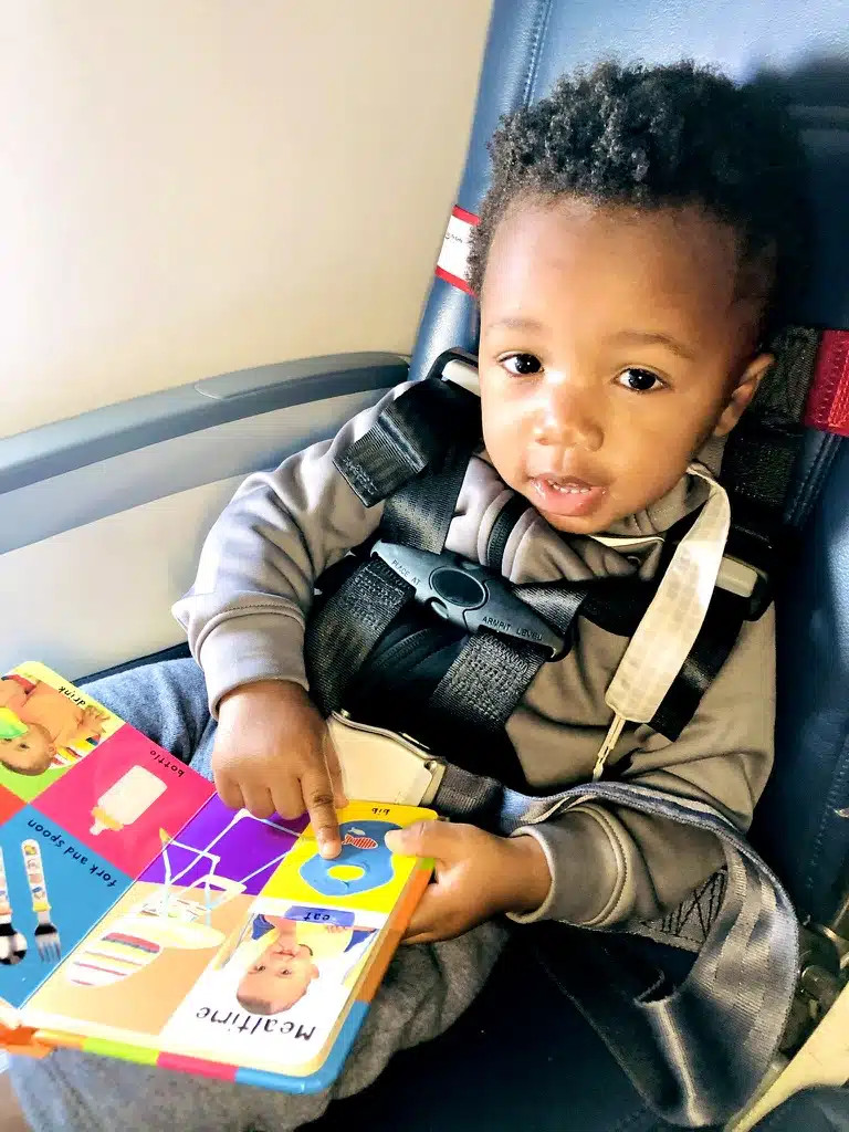 Toddler using CARES Harness on a plane
