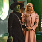 Elphaba and Glinda in a scene from Wicked, showcasing their complex relationship